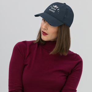 distressed baseball cap navy blue, with image phrase "Moon Maiden," and image graphic of moon phases. background:  Christmas gifts.