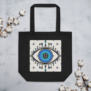 black colored tote bag with image of eye of protection/evil eye, colors of golden yellow, blue, light blue, third eye, eye, celestial stars. certified organic, cotton.