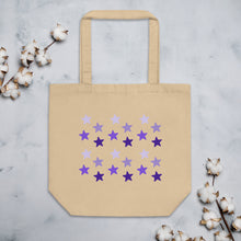 Load image into Gallery viewer, oyster colored tote bag, certified organic, cotton, features rows of purple stars, with each row darker than the one above it, creating a striking gradient effect. 4 shades of purple. 
