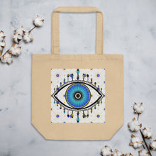 Load image into Gallery viewer, oyster colored tote bag with image of eye of protection/evil eye, colors of golden yellow, blue, light blue, third eye, eye, celestial stars. certified organic, cotton.
