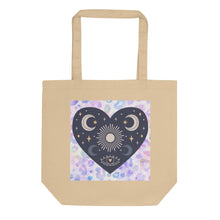 Load image into Gallery viewer, oyster colored tote bag, certified organic. Image design: blue mystical heart with eye in middle, and crescent moons, and a light purple leopard print background behind the image
