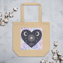 Load image into Gallery viewer, oyster colored tote bag, cotton, certified organic. Image design: blue mystical heart with eye in middle, and crescent moons, and a light purple leopard print background behind the image
