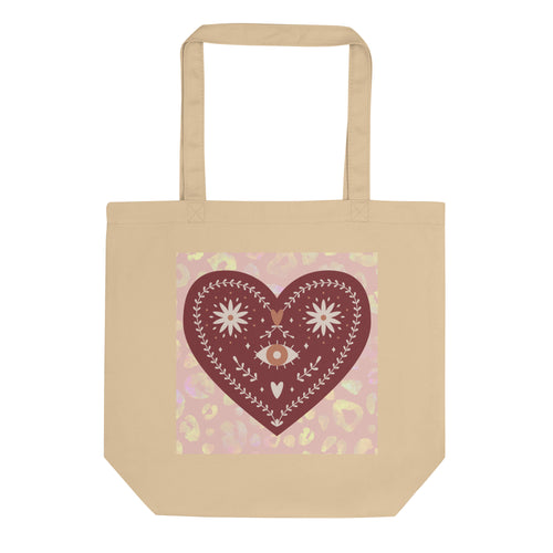 oyster colored tote bag, certified organic. Image design: boho warm red mystical heart with eye in middle, and daisies, and a light red-gold leopard print background behind the image