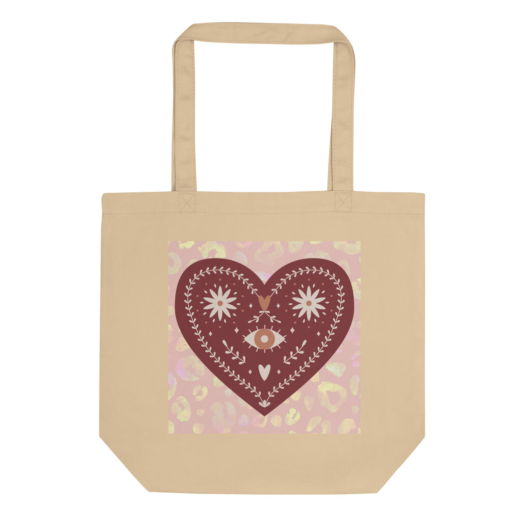 oyster colored tote bag, certified organic. Image design: boho warm red mystical heart with eye in middle, and daisies, and a light red-gold leopard print background behind the image