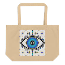 Load image into Gallery viewer, large oyster colored tote bag with image of eye of protection/evil eye, colors of golden yellow, blue, light blue, third eye, eye, celestial stars. certified organic
