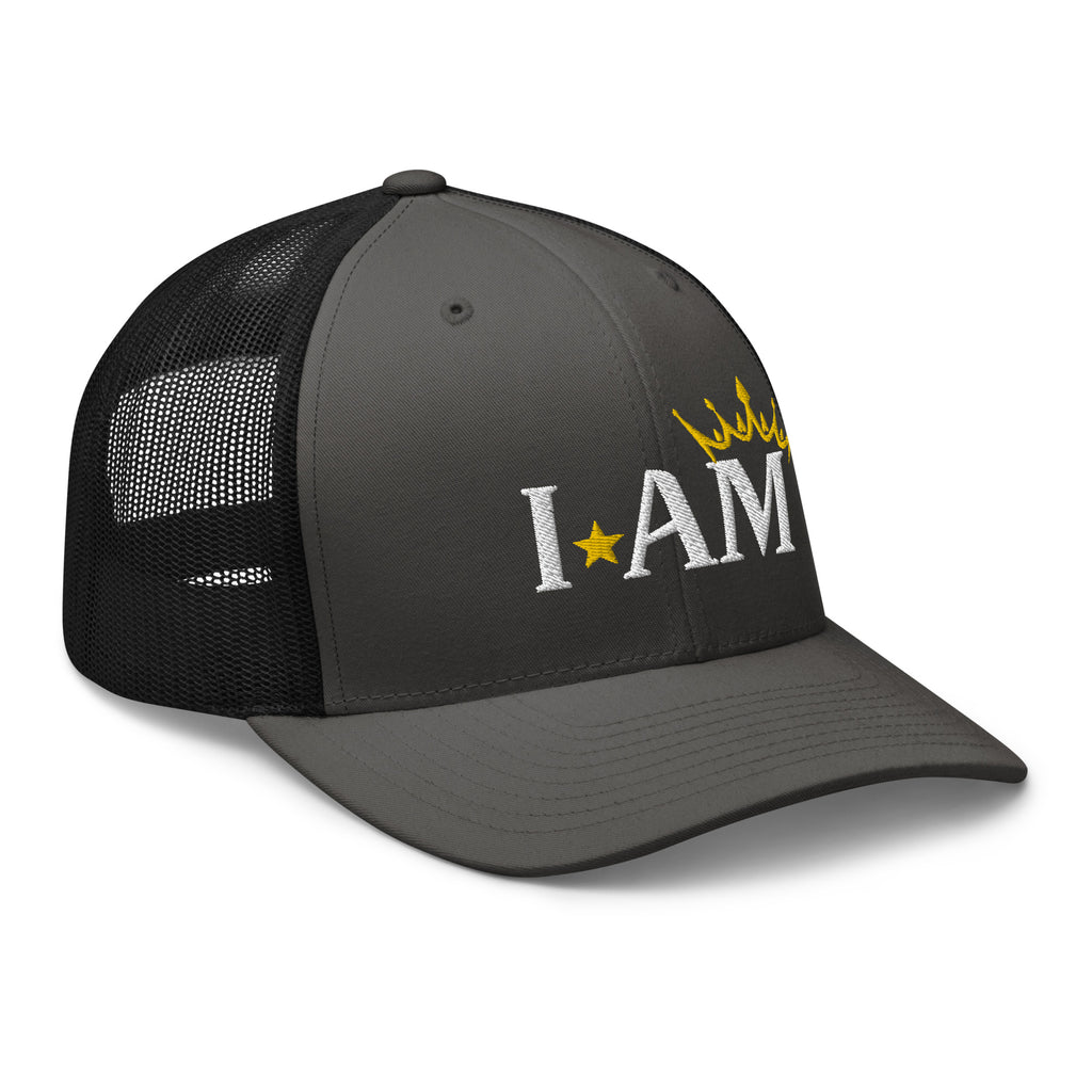 retro trucker hat charcoal grey black, with image phrase: "I AM," with image graphic of a gold crown over the letter M. side view.