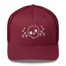 Load image into Gallery viewer, retro trucker hat/cap cranberry red, with image design of a cartoonish cute skull with heart eyes, a heart bow, and stars. Front view.
