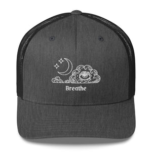 retro trucker hat/cap dark grey heather , with image design of an eye in a cloud, with moon crescent and stars, with the word "Breathe" underneath the image.  Front view.