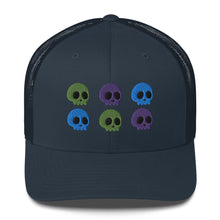 Load image into Gallery viewer, retro trucker hat navy blue, with image design of 6 purple, green, and blue skulls, 2 of each color, in two rows.  Front view.
