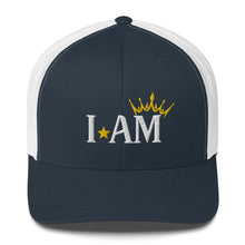 Load image into Gallery viewer, retro trucker hat navy blue white, with image phrase: &quot;I AM,&quot; with image graphic of a gold crown over the letter M. Front view.
