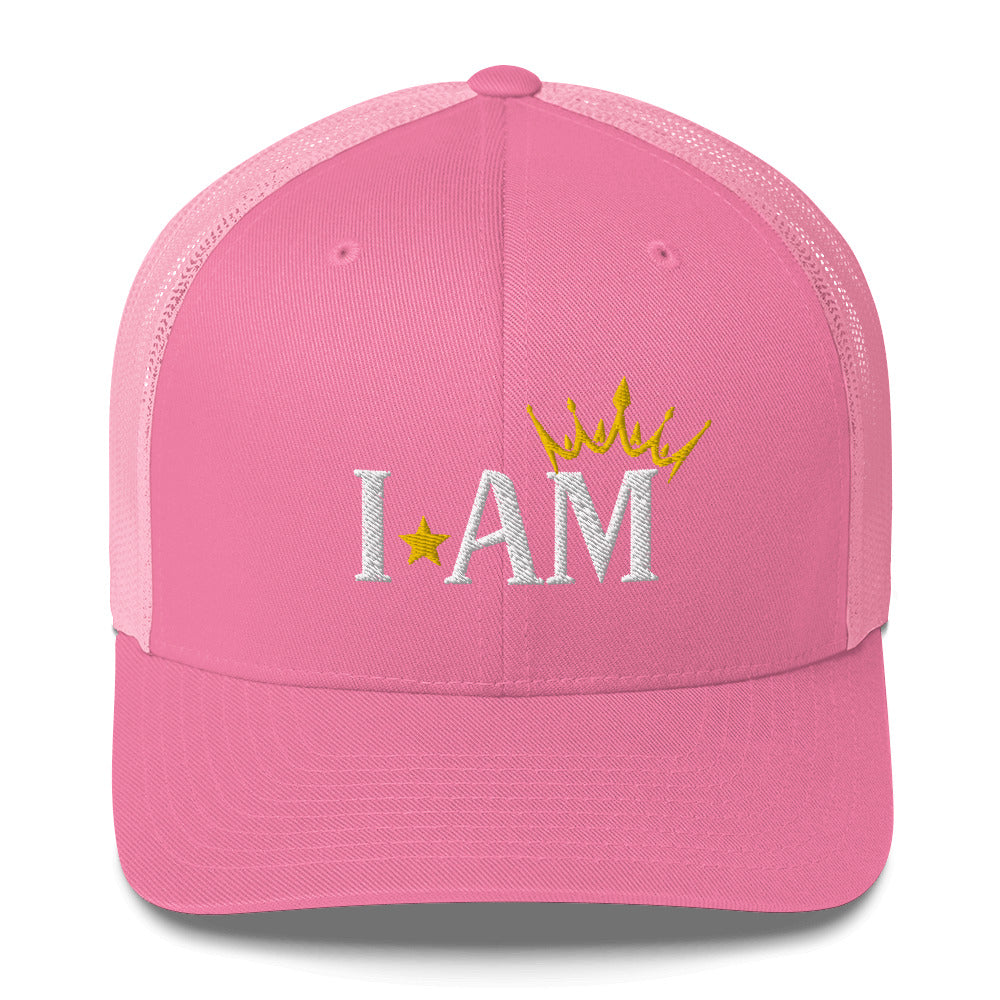 retro trucker hat pink , with image phrase: "I AM," with image graphic of a gold crown over the letter M. Front view.