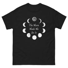 Load image into Gallery viewer, unisex black t-shirt with image phrase: The moon made me do it. Bordered with Moon phases. Front view. Halloween, spooky season.
