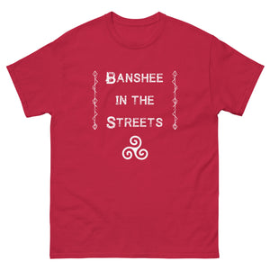 unisex red t-shirt with image phrase: Banshee in the Streets. tribal symbols on both sides. Triskele at the bottom under phrase. Front view. Halloween, spooky season.