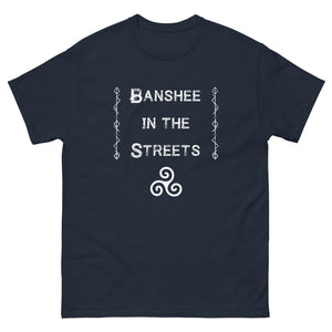 unisex navy blue t-shirt with image phrase: Banshee in the Streets. tribal symbols on both sides. Triskele at the bottom under phrase. Front view. Halloween, spooky season.