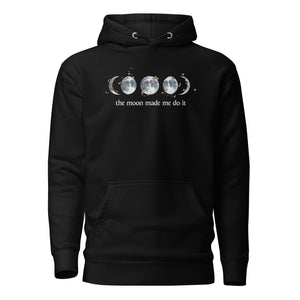 unisex black hoodie with image phrase "The moon made me do it." With image graphic of watercolor moon phases, decorated with random gold star constellations. Front view.