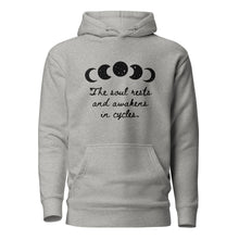 Load image into Gallery viewer, unisex carbon grey hoodie with image phrase &quot;The soul rests and awakens in cycles.&quot; With image graphic of silhouette moon phases with star cut outs. Front view.
