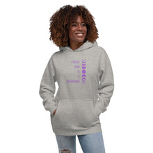 Load image into Gallery viewer, Woman modeling/wearing carbon grey unisex hoodie, with pockets, with image phrase: &quot;Every end is a beginning.&quot; with image of moon phases, from new moon, to full moon, back to new moon. Front view.
