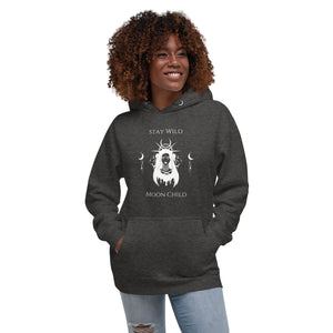 woman modeling/wearing charcoal grey heather unisex hoodie, with pockets, with image phrase: "Stay wild, Moon Child." with image of three tribal woman heads, with moon crown, and crescent moons on sides.