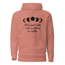 Load image into Gallery viewer, unisex dusty rose peach/pink hoodie with image phrase &quot;The soul rests and awakens in cycles.&quot; With image graphic of silhouette moon phases with star cut outs. Front view.
