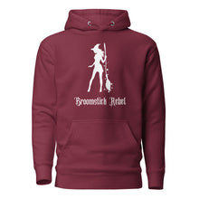 Load image into Gallery viewer, maroon unisex hoodie, with pockets. Image design: silhouette of a pretty witch holding a magical broom, stars. Image phrase: Broomstick rebel. Front view.
