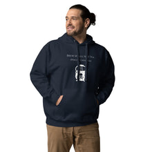 Load image into Gallery viewer, Man modeling/wearing Unisex navy blue hoodie with image phrase: &quot;Brew spells, not tea (pinche chismosa).&quot; Underneath words is an image of a cauldron decorated with stars and skull with crossbones. Front view. Halloween, spooky season.
