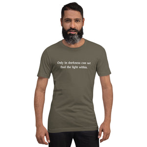 man modeling/wearing unisex army green t-shirt, with image phrase: "only in darkness can we find the light within." Front view.