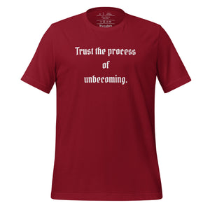 unisex cardinal red t-shirt, with image phrase: "Trust the process of unbecoming" Front view.