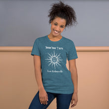 Load image into Gallery viewer, Woman modeling/wearing Unisex heather deep teal t-shirt with Image Design: Text &quot;Honor your truth, Live authentically,&quot; with center image of sun, eye in center of sun, moon in the eye&#39;s iris, stars all around.
