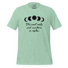 Load image into Gallery viewer, unisex heather prism mint green t-shirt, with image of black celestial moon phases, with star cut outs, and image phrase &quot;The soul rests and awakens in cycles.&quot; Front view.
