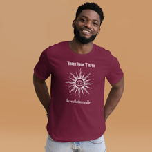 Load image into Gallery viewer, Man modeling/wearing Unisex maroon t-shirt with Image Design: Text &quot;Honor your truth, Live authentically,&quot; with center image of sun, eye in center of sun, moon in the eye&#39;s iris, stars all around.
