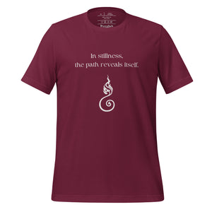 unisex maroon t-shirt with image phrase "In stillness, the path reveals itself" with image design of curvy, fiery unalome. Front view.