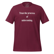 Load image into Gallery viewer, unisex maroon t-shirt, with image phrase: &quot;Trust the process of unbecoming&quot; Front view.
