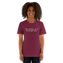 Load image into Gallery viewer, woman modeling/wearing unisex maroon t-shirt, with image phrase: &quot;only in darkness can we find the light within.&quot; Front view.
