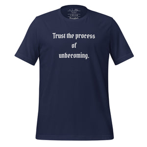 unisex navy blue t-shirt, with image phrase: "Trust the process of unbecoming" Front view.