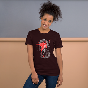 woman modeling/wearing unisex oxblood black t-shirt, with image design of an angel kissing a woman, with a red paint splat seen through their outlines. Front view.