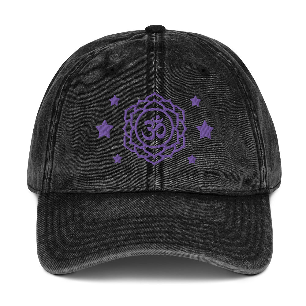 vintage denim cap black, with image design of purple third eye chakra symbol, and stars. Front view.