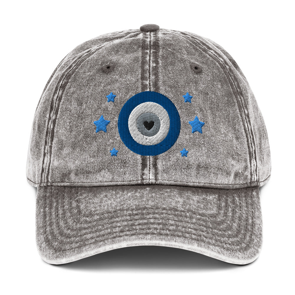 vintage denim cap charcoal grey, with image design of blue eye of protection/evil eye/third eye, with stars. Front view.