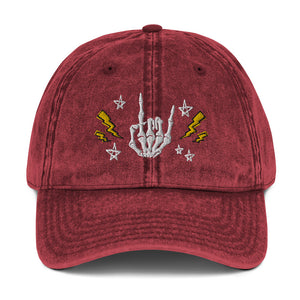 vintage denim cap maroon, with image design of rock on skeleton hand, pentagram stars, lightning symbols. 