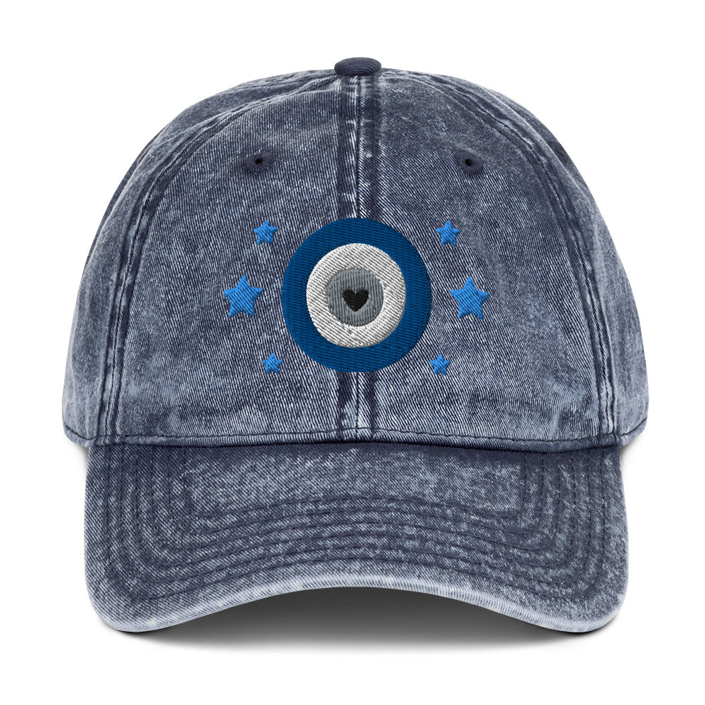 vintage denim cap navy blue, with image design of blue eye of protection/evil eye/third eye, with stars. Front view.