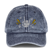 Load image into Gallery viewer, vintage denim cap navy blue, with image design of rock on skeleton hand, pentagram stars, lightning symbols. 
