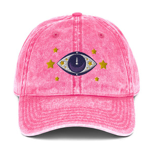 vintage denim cap pink, with image design of blue eye of protection/evil eye/third eye, with stars. Front view.