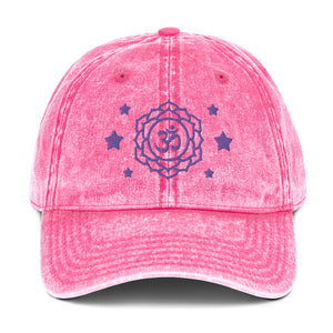 vintage denim cap pink, with image design of purple third eye chakra symbol, and stars. Front view.