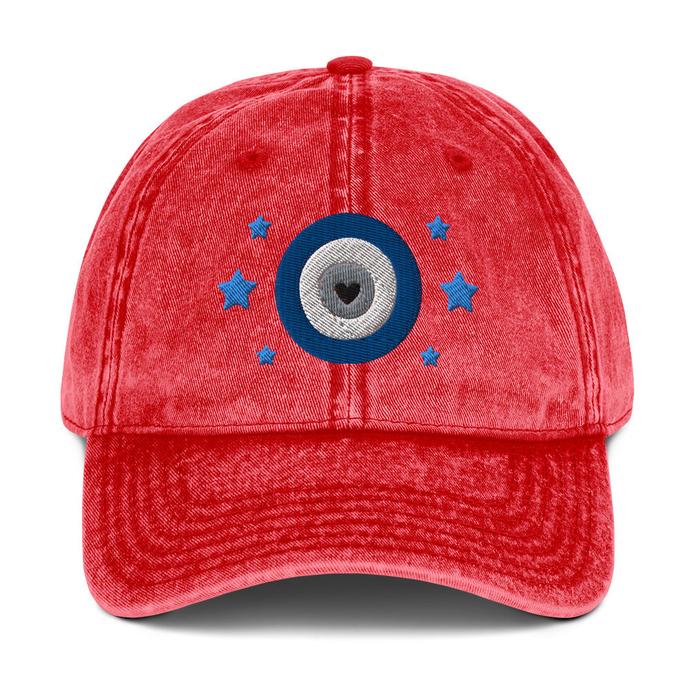 vintage denim cap red, with image design of blue eye of protection/evil eye/third eye, with stars. Front view.