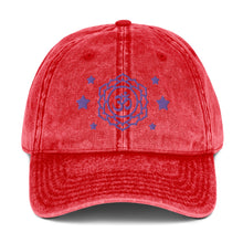 Load image into Gallery viewer, vintage denim cap red, with image design of purple third eye chakra symbol, and stars. Front view.
