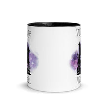 Load image into Gallery viewer, 11 oz. white ceramic coffee/tea mug with solid black handle, rim, and inside. Image Design: silhouette of black haunted house, cosmic purple cloud in background. Image phrase: Village witch. Center front view. Halloween, spooky season.
