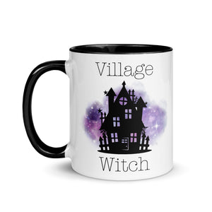 11 oz. white ceramic coffee/tea mug with solid black handle, rim, and inside. Image Design: silhouette of black haunted house, cosmic purple cloud in background. Image phrase: Village witch. Left hand side view. Halloween, spooky season.