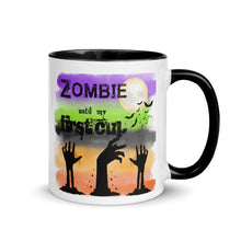 Load image into Gallery viewer, 11 oz. white ceramic coffee/tea mug with solid black handle, rim, and inside. Image Design: silhouette of zombie hands reaching out of ground, background colors orange, light orange, grey-black, light green, purple, moon and bats in background. Image phrase: Zombie until my first cup. right hand side view. Halloween, spooky season.
