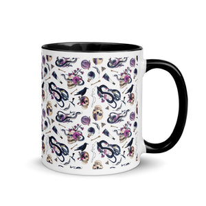 11 oz. white ceramic coffee/tea mug with solid black handle, rim, and inside. Image Design: gothic theme patter of skulls, wands, snakes, ravens, purple flowers. right hand side view. 
Halloween, spooky season.