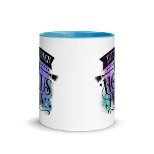 11 oz. white ceramic coffee/tea mug with solid light blue handle, rim, and inside. Image Design: phrase "just a bunch of Hocus Pocus, with mini image of pumpkin and broom,  whimsical font. backed by blue and purple cosmic cloud. Image phrase: Just a bunch of Hocus Pocus. Center front view. Halloween, spooky season.