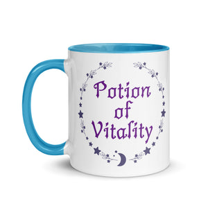 11 oz. white ceramic coffee/tea mug with solid light blue handle, rim, and inside. Image Design: Purple words 'Potion of Vitality' bordered by stars, leaves, and crescent moon at the bottom. Image phrase: Potion of Vitality. Left hand side view. Halloween, spooky season.